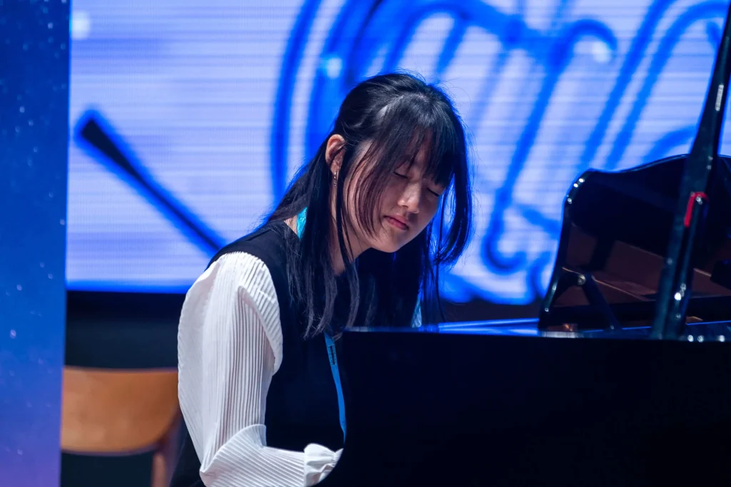 Youth Educational Friendship Festival piano performance from teenage group